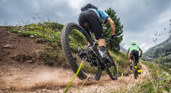 A ground view of two MTB'er from the back on MTB eBikes